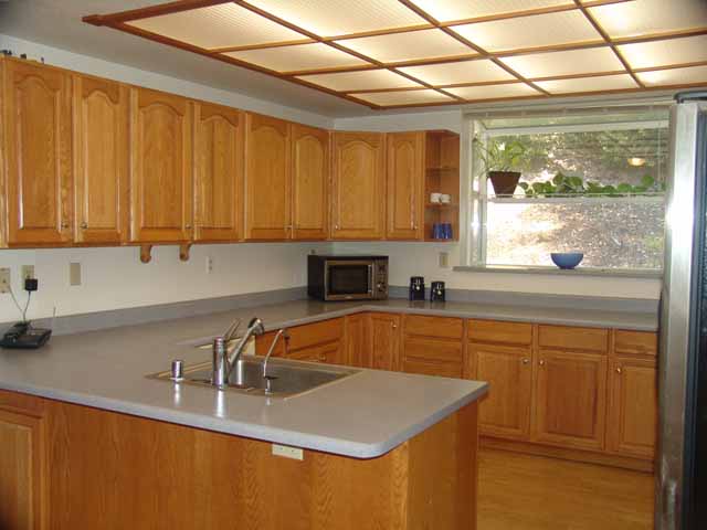 country kitchen with greenhouse window, propane range, refrigerator and dishwasher included.